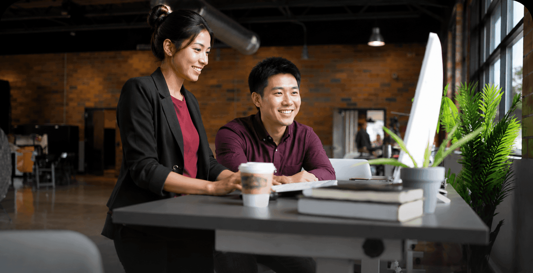 Two advisers working together at a desk