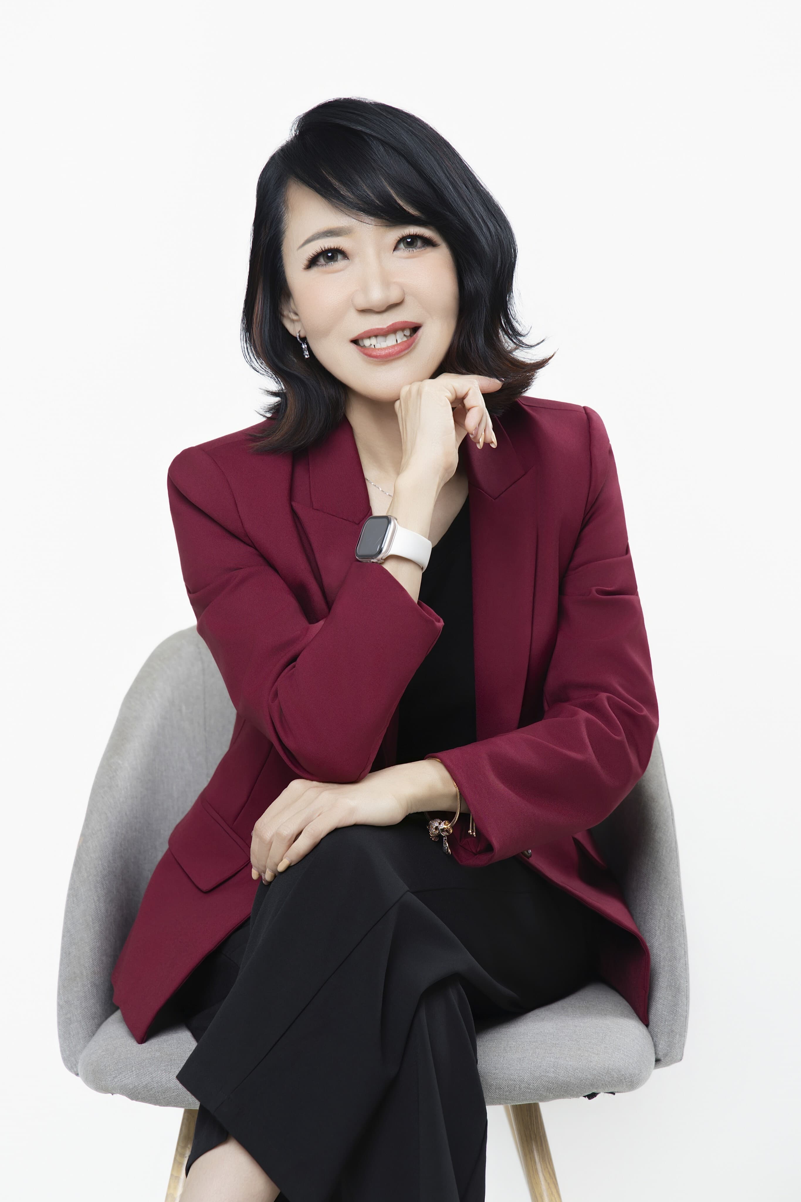Portrait of the Vinsure principal in a burgundy blazer